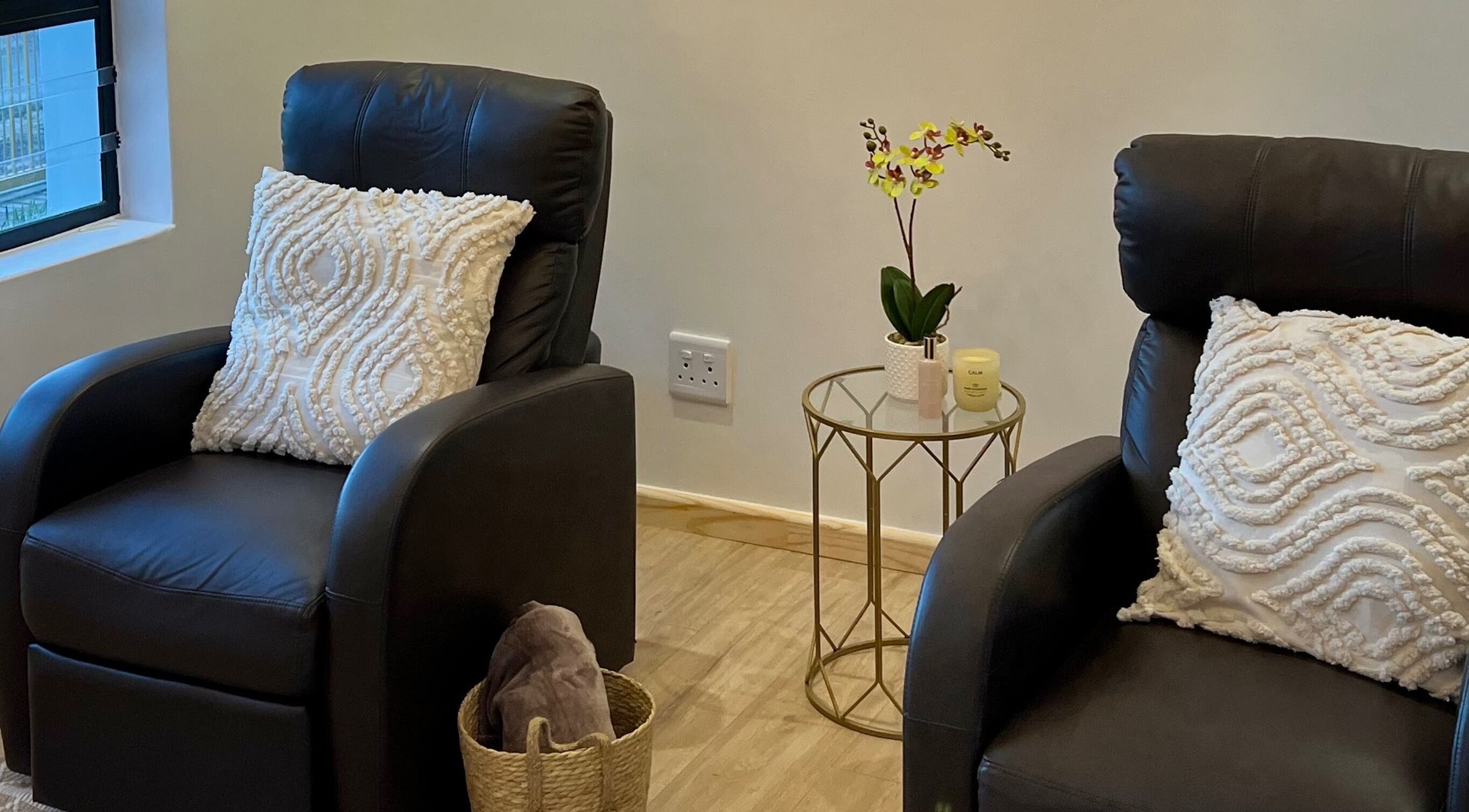 Relaxing lounge area at Orchid Aesthetics ZA in Cape Town, Western Cape, ZA with plush chairs and decor.