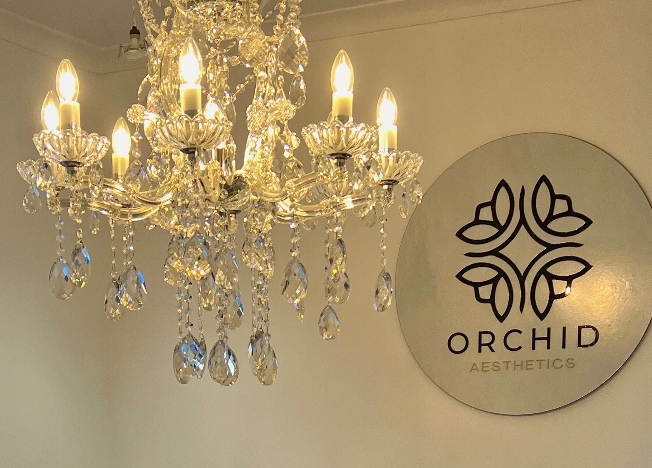 Crystal chandelier illuminating Orchid Aesthetics ZA entrance in Cape Town, Western Cape, ZA.