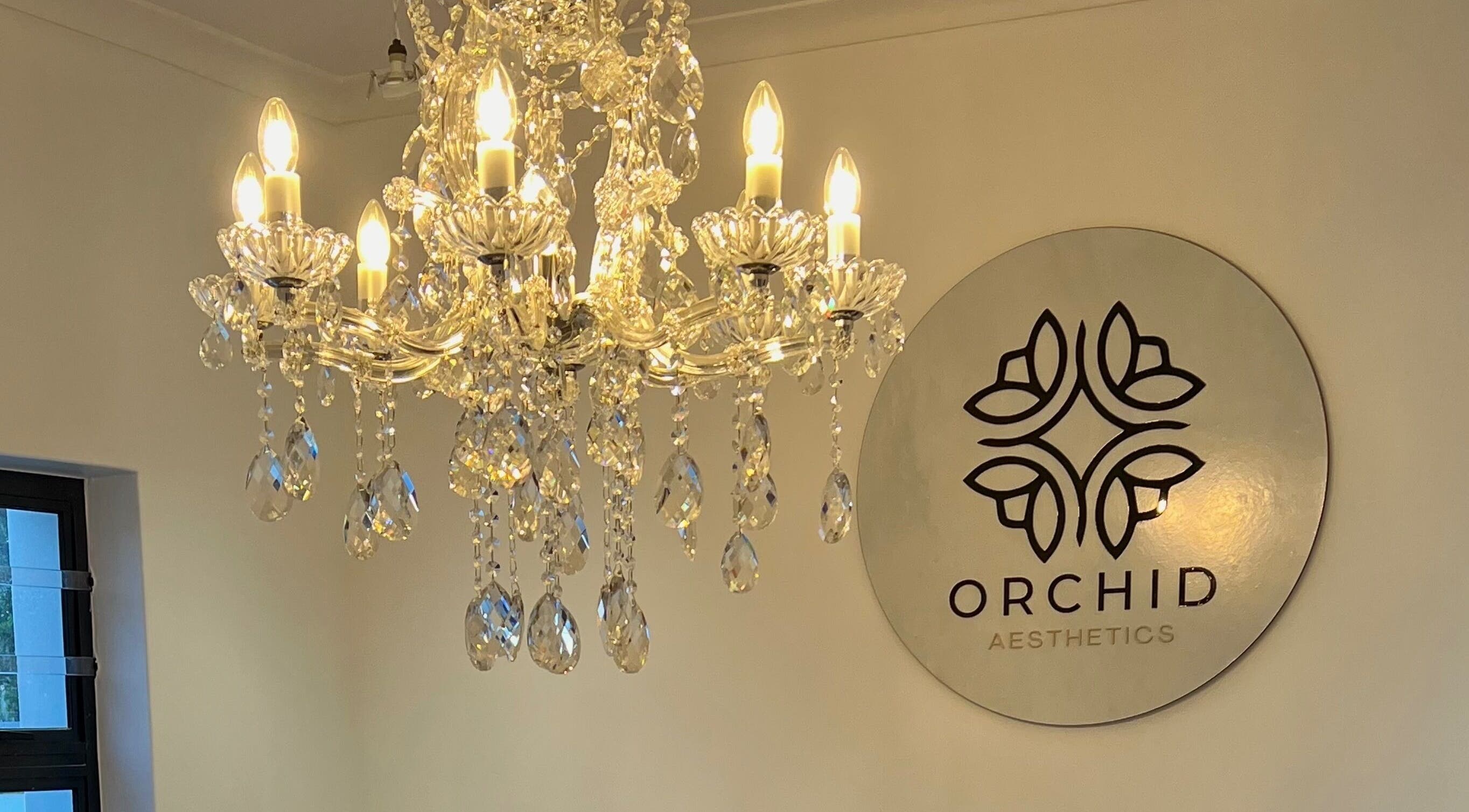 Crystal chandelier illuminating Orchid Aesthetics ZA entrance in Cape Town, Western Cape, ZA.