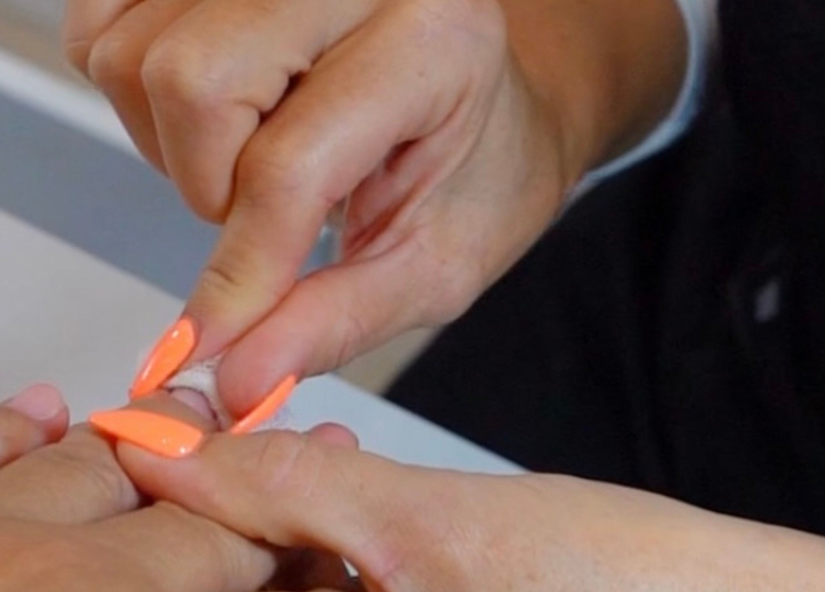 Nail artist applying vibrant polish at Gloglam, Main Beach, Queensland, AU.