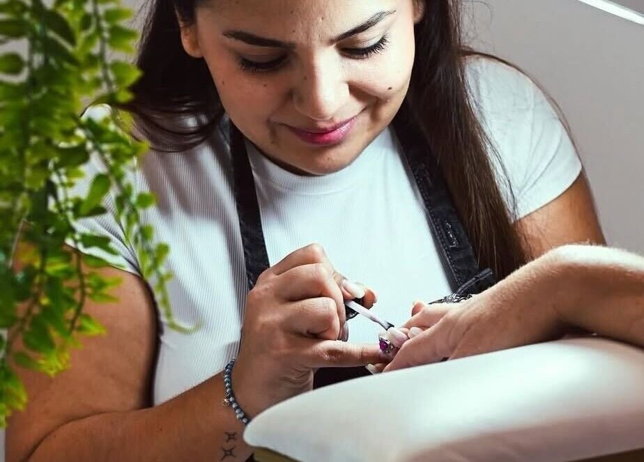 Expert nail technician at Gloglam, Main Beach, Queensland, AU, offers precise manicure service.