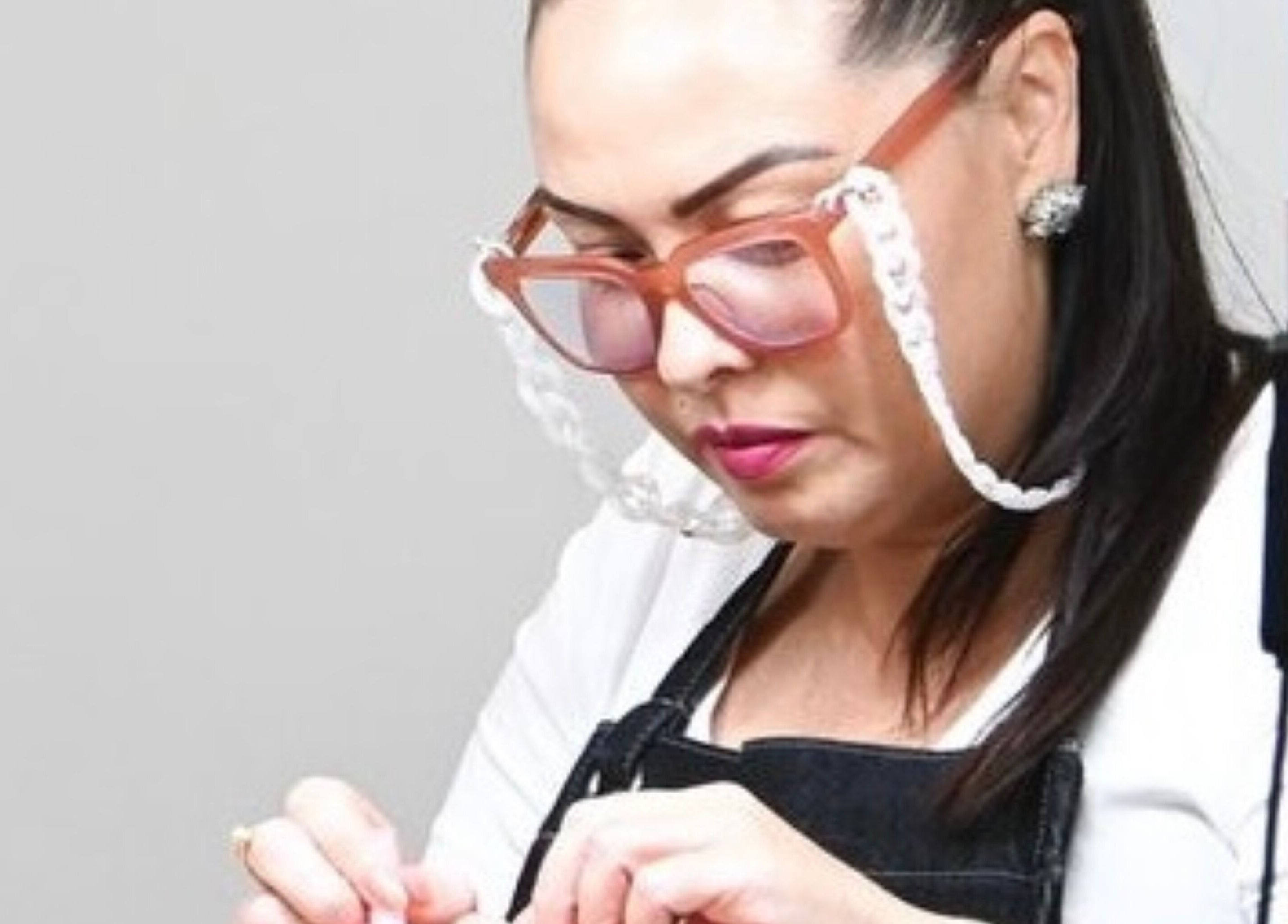 Professional beautician at Gloglam, Main Beach, Queensland, AU, performing detailed beauty work.