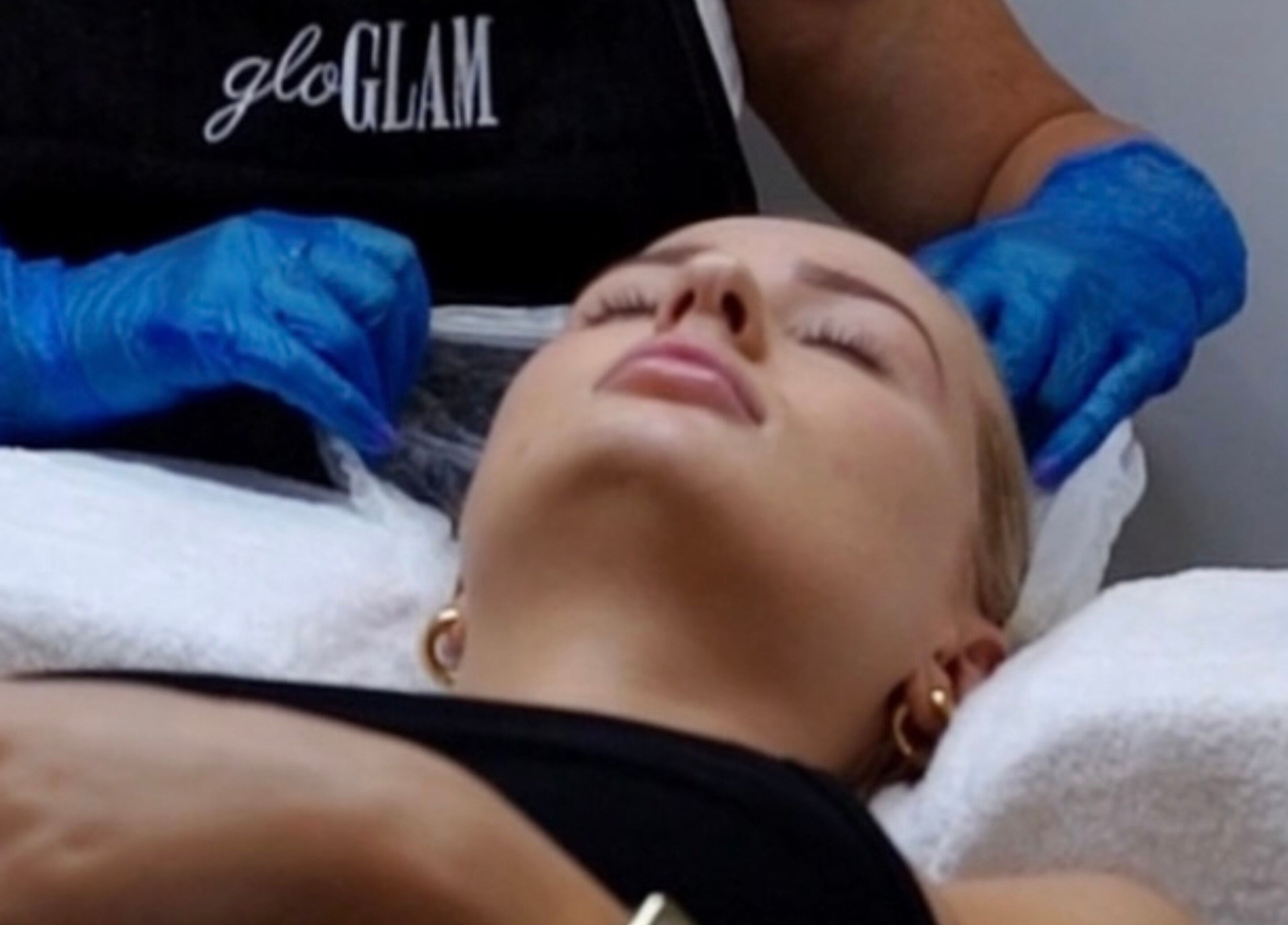 Relaxing facial treatment at Gloglam in Main Beach, Queensland, AU. Professional care with blue gloves.