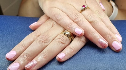 Elegant pink manicure with glitter accent at The Beauty Pond, Swindon, England, GB.