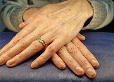 Elegant hands with golden nail art at The Beauty Pond, Swindon, England, GB.