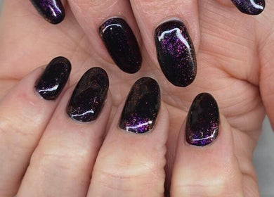 Purple glitter nail art at The Beauty Pond, Swindon, England, GB. Perfectly manicured nails shine vibrantly.