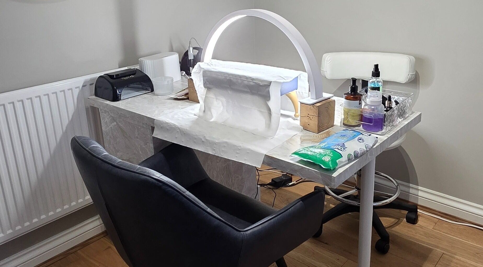 Manicure station at The Beauty Pond, Swindon, England, GB with a sleek chair and nail equipment.