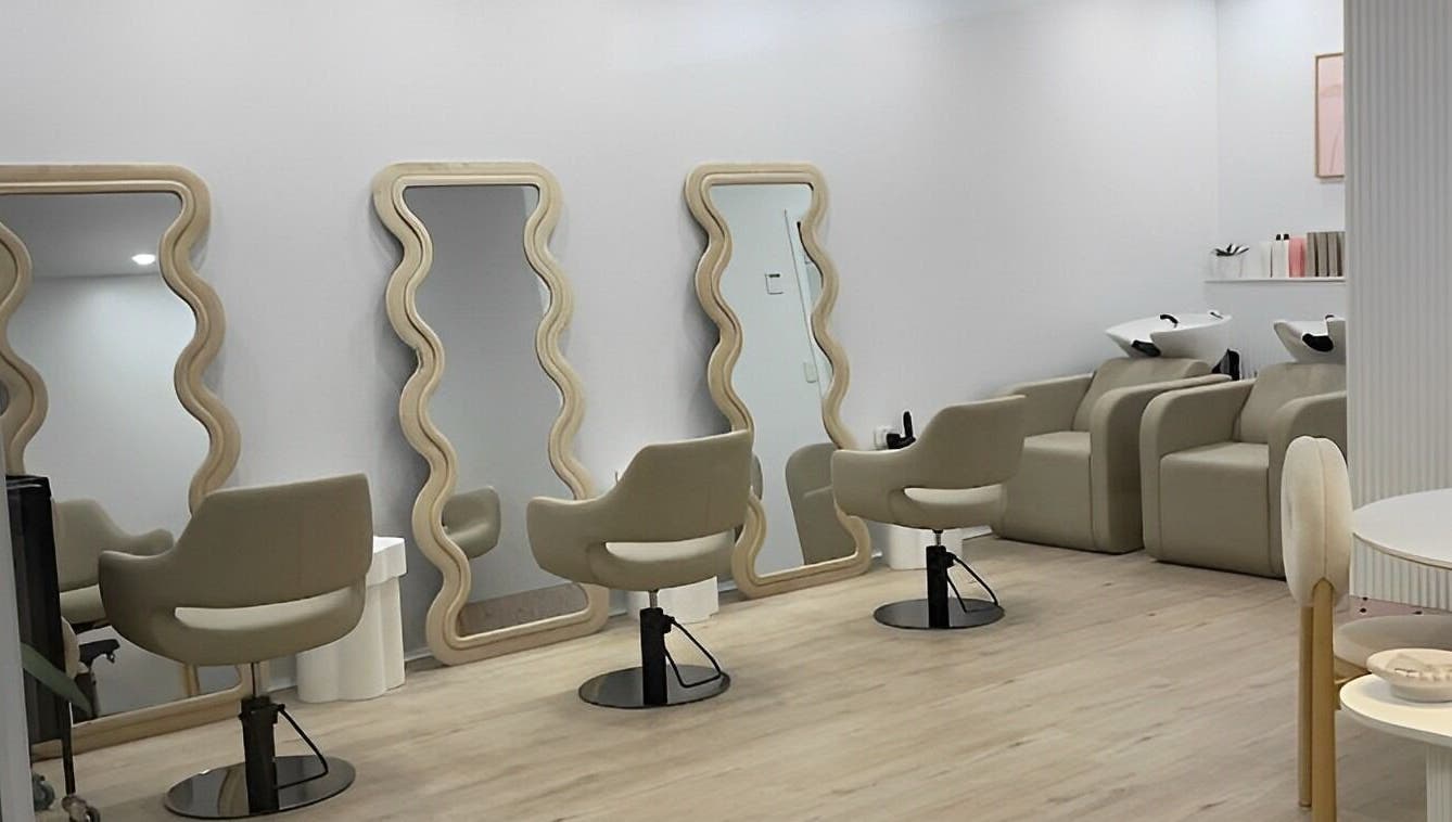 Chic interior of StudioBlonde By Tahlia, Mona Vale, NSW, with stylish mirrors and comfortable chairs.