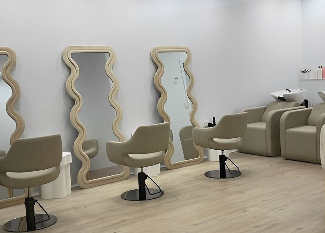 Chic interior of StudioBlonde By Tahlia, Mona Vale, NSW, with stylish mirrors and comfortable chairs.