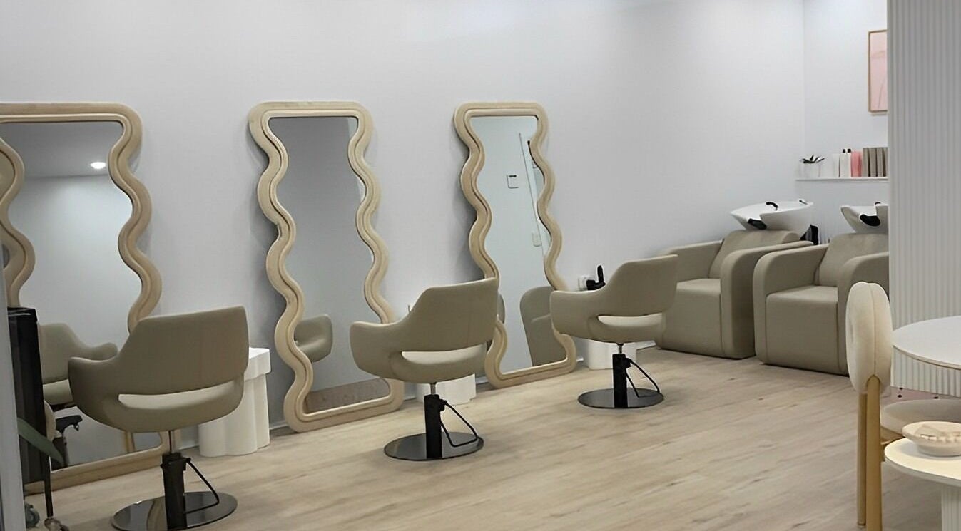 Chic interior of StudioBlonde By Tahlia, Mona Vale, NSW, with stylish mirrors and comfortable chairs.