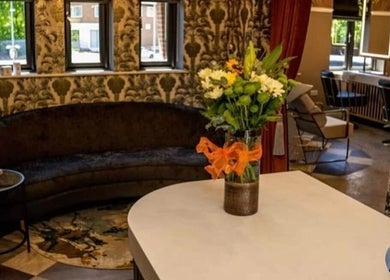 Interior of Kelly Michelle Hair Design, Stockton-on-tees, England with chic decor and floral centerpiece.