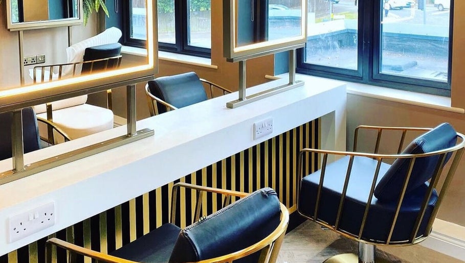 Modern salon interior at Kelly Michelle Hair Design in Stockton-on-tees, England, GB, featuring sleek styling chairs.
