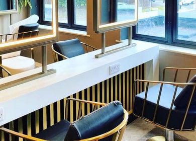 Modern salon interior at Kelly Michelle Hair Design in Stockton-on-tees, England, GB, featuring sleek styling chairs.