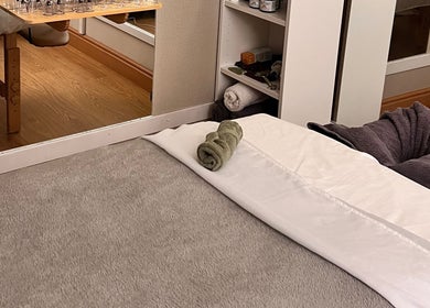 Calming massage room at Mind & Soul Massage Therapy in Dublin, County Dublin, IE, with plush towels and soothing decor.