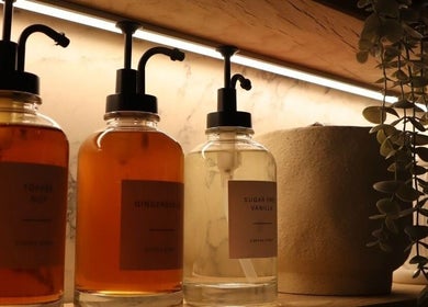 Warm lighting highlights elegant bottles at Laird & Co by Christopher Laird, Edinburgh, Scotland, GB.