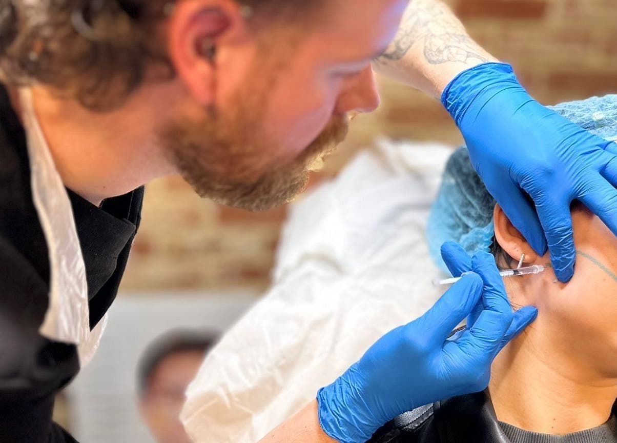 Expert performing aesthetic treatment at Hair & Aesthetics By Ryan, Wyboston, England, GB.