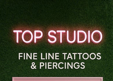 Neon sign of Top Studio Tattoo & Piercing located in Toronto, Ontario, CA, highlighting fine line tattoos.