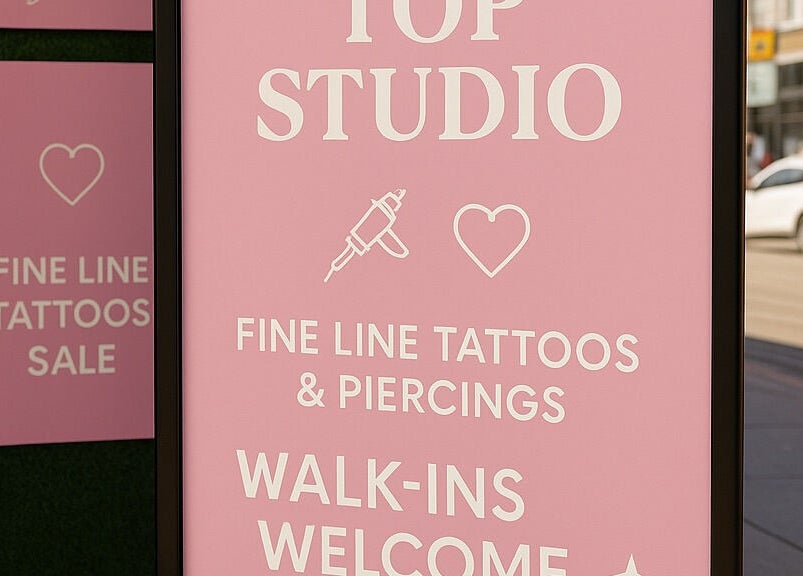 Elegant pink sign of Top Studio Tattoo & Piercing in Toronto, Ontario, CA welcoming walk-ins.
