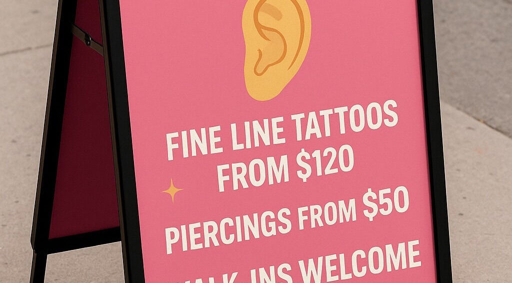 Signboard for Top Studio Tattoo & Piercing in Toronto, Ontario, CA, offering tattoos from $120 and piercings from $50.
