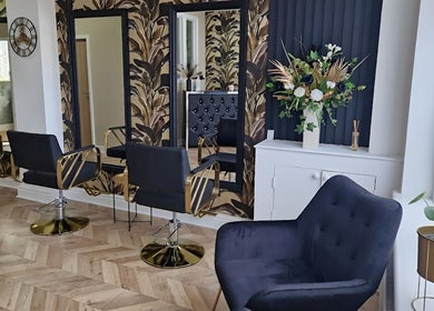 Chic interior of The Hair Lounge in Chorley, England, GB, featuring stylish salon chairs and modern decor.