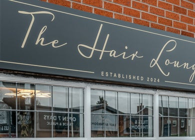 The Hair Lounge storefront sign in Chorley, England, GB, featuring elegant typography, established 2024.