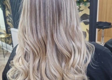 Blonde hair styled in elegant waves at The Hair Lounge, Chorley, England, GB.