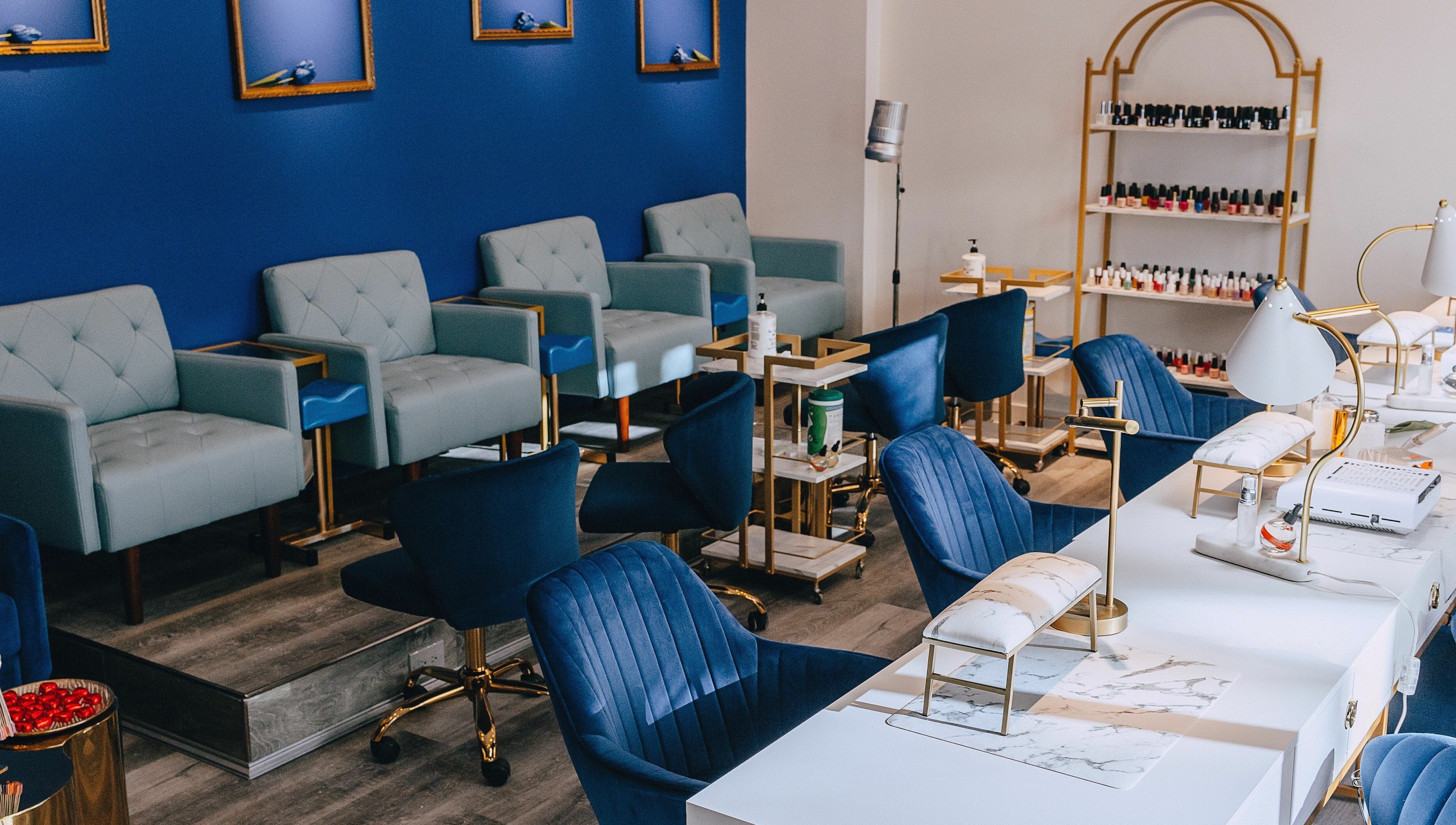 Modern salon seating at Mon Cheri Chitown, Chicago, Illinois, US with blue decor and luxury chairs.
