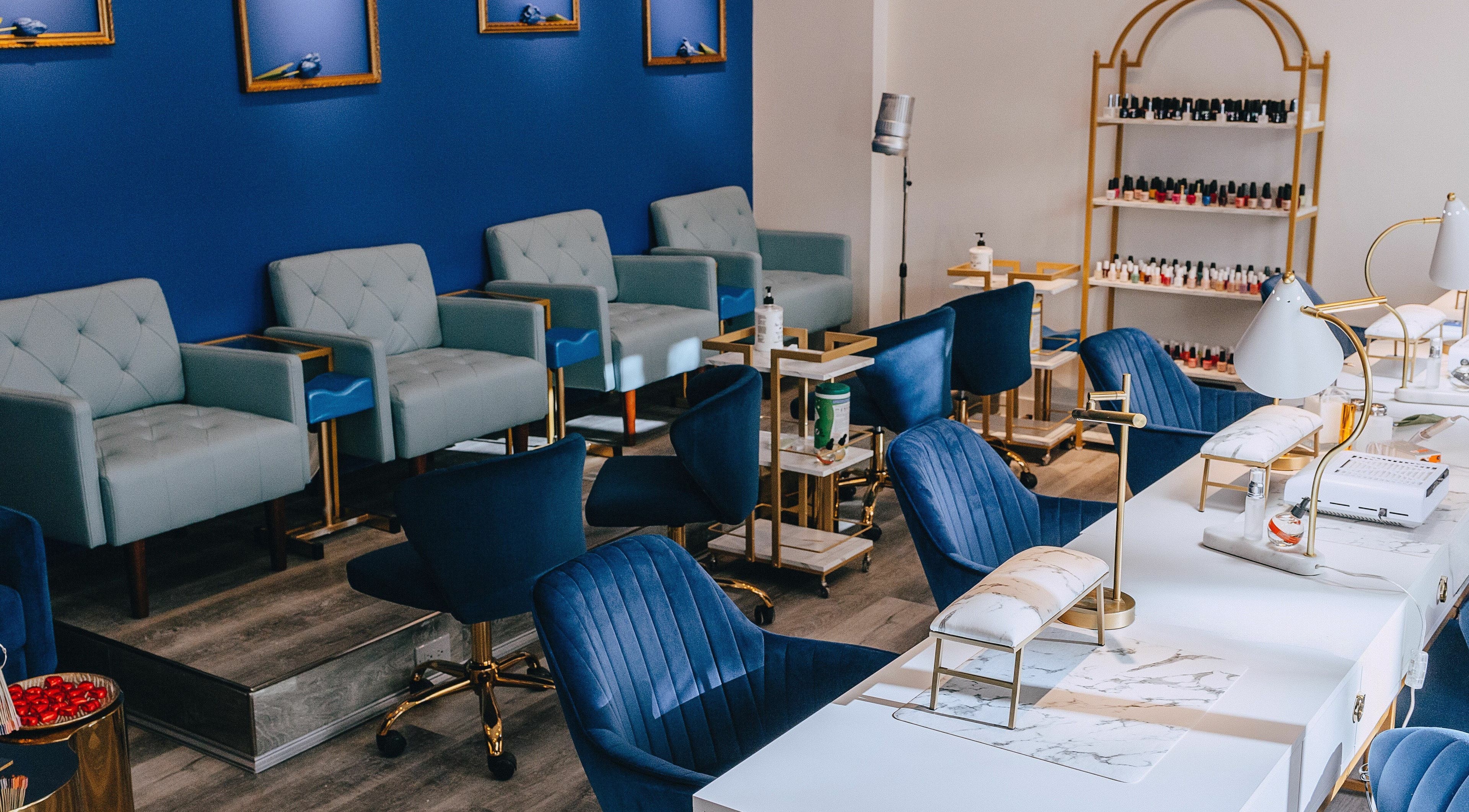 Modern salon seating at Mon Cheri Chitown, Chicago, Illinois, US with blue decor and luxury chairs.