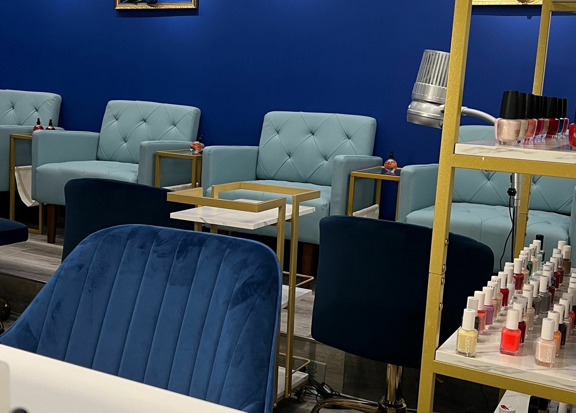 Inviting lounge at Mon Cheri Chitown in Chicago, Illinois, US with plush seating and nail polish display.