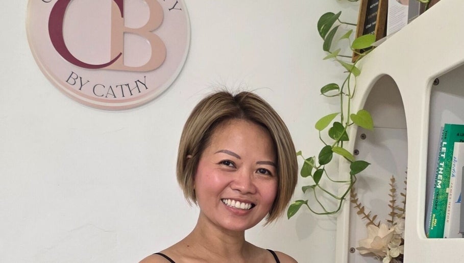 Friendly stylist at Complete Beauty by Cathy, Neutral Bay, New South Wales, AU, welcomes clients in a chic setting.