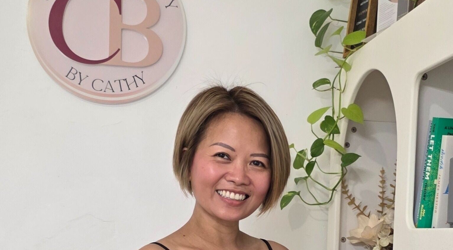 Friendly stylist at Complete Beauty by Cathy, Neutral Bay, New South Wales, AU, welcomes clients in a chic setting.