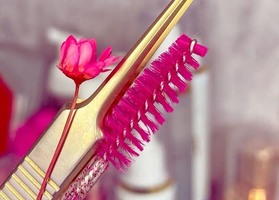 Close-up of a gold lash tool with a pink flower at Isa Paula Lashes and Beauty, London, England, GB.
