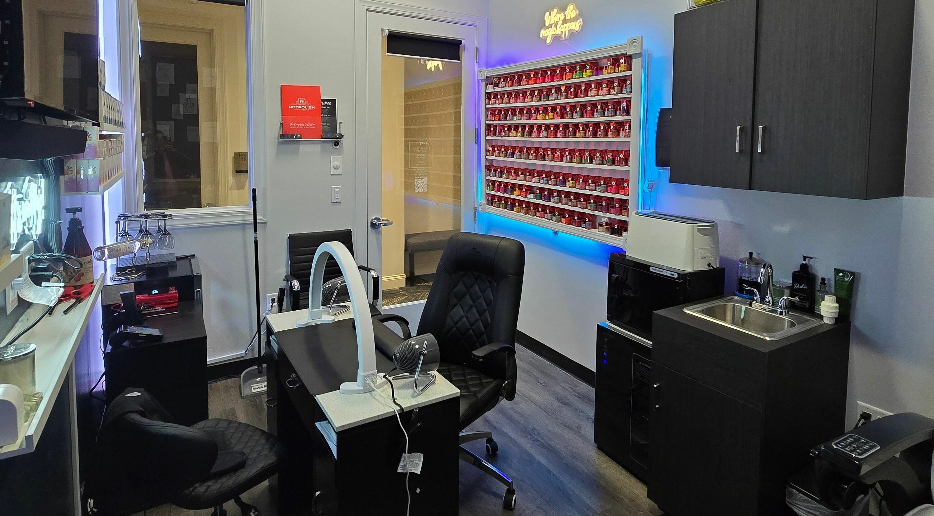 Modern nail salon interior at Mr. Right Nails at Phenix Salon Suites, Columbus, Ohio, US, showcasing vibrant polish wall.