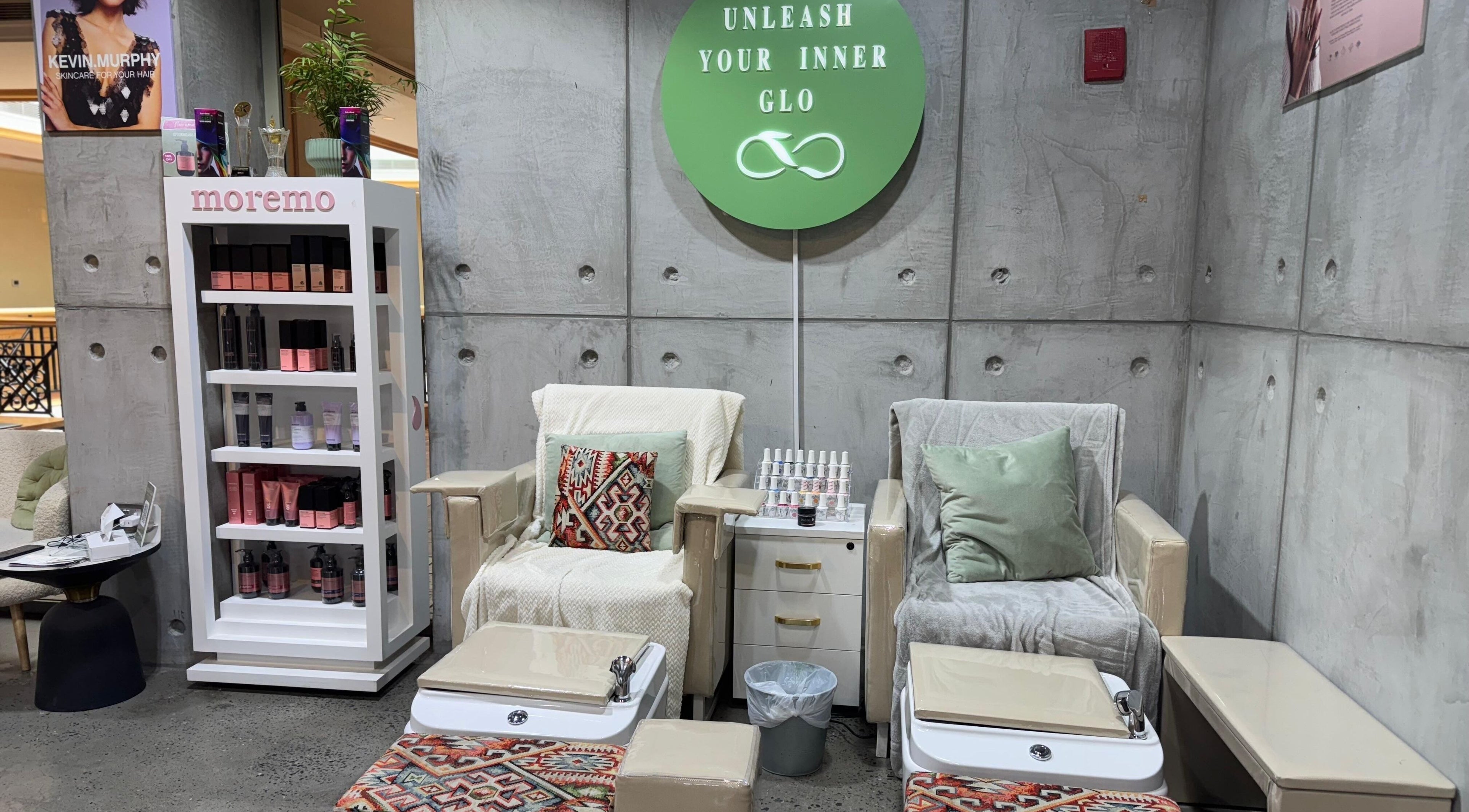 Tee & Glo Beauty lounge in Dubai, Dubai, AE with cozy pedicure chairs and skincare products.