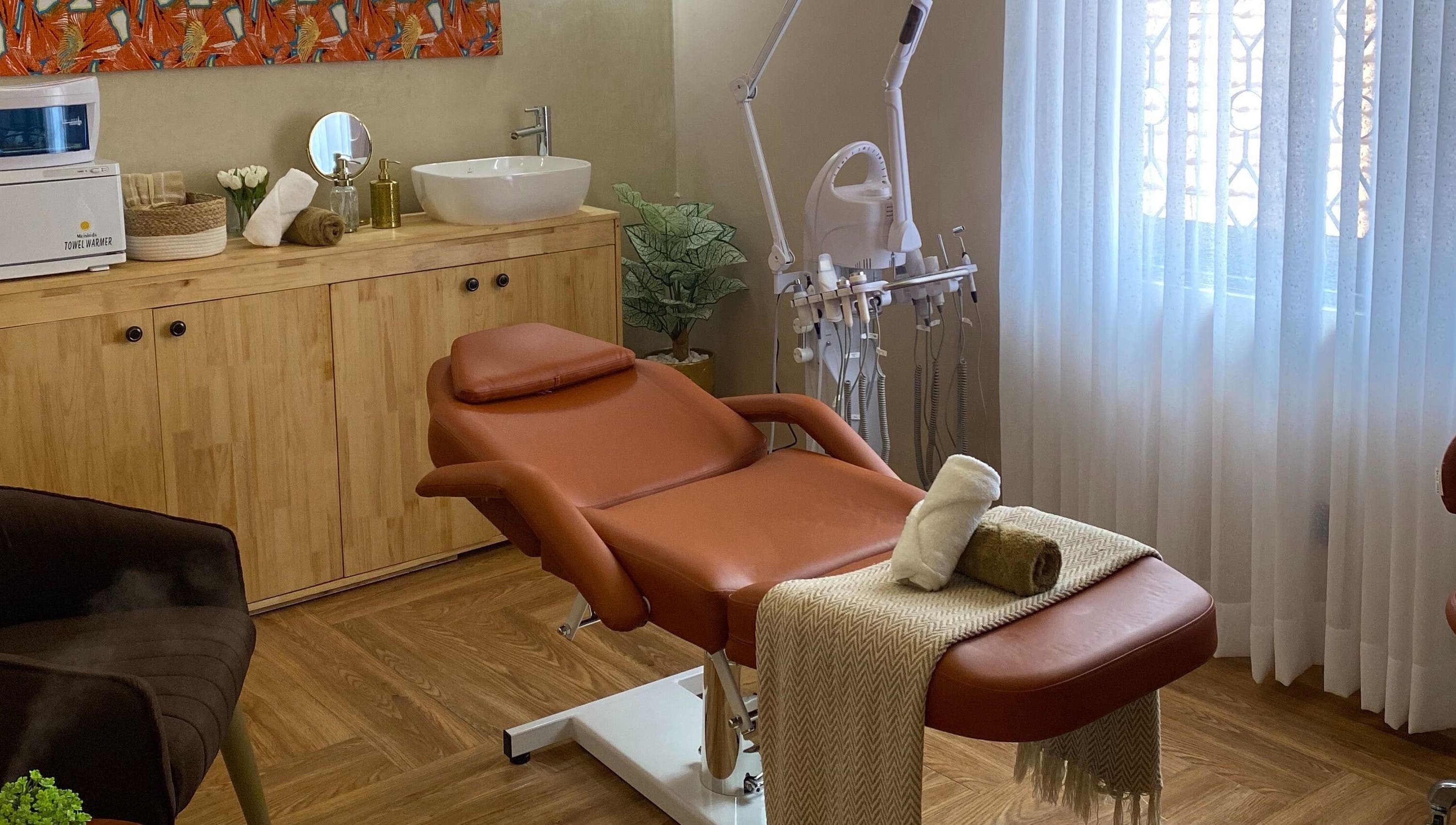 Relaxing treatment room at The Pod, Kampala, Central Region, UG with massage chair and soothing decor.