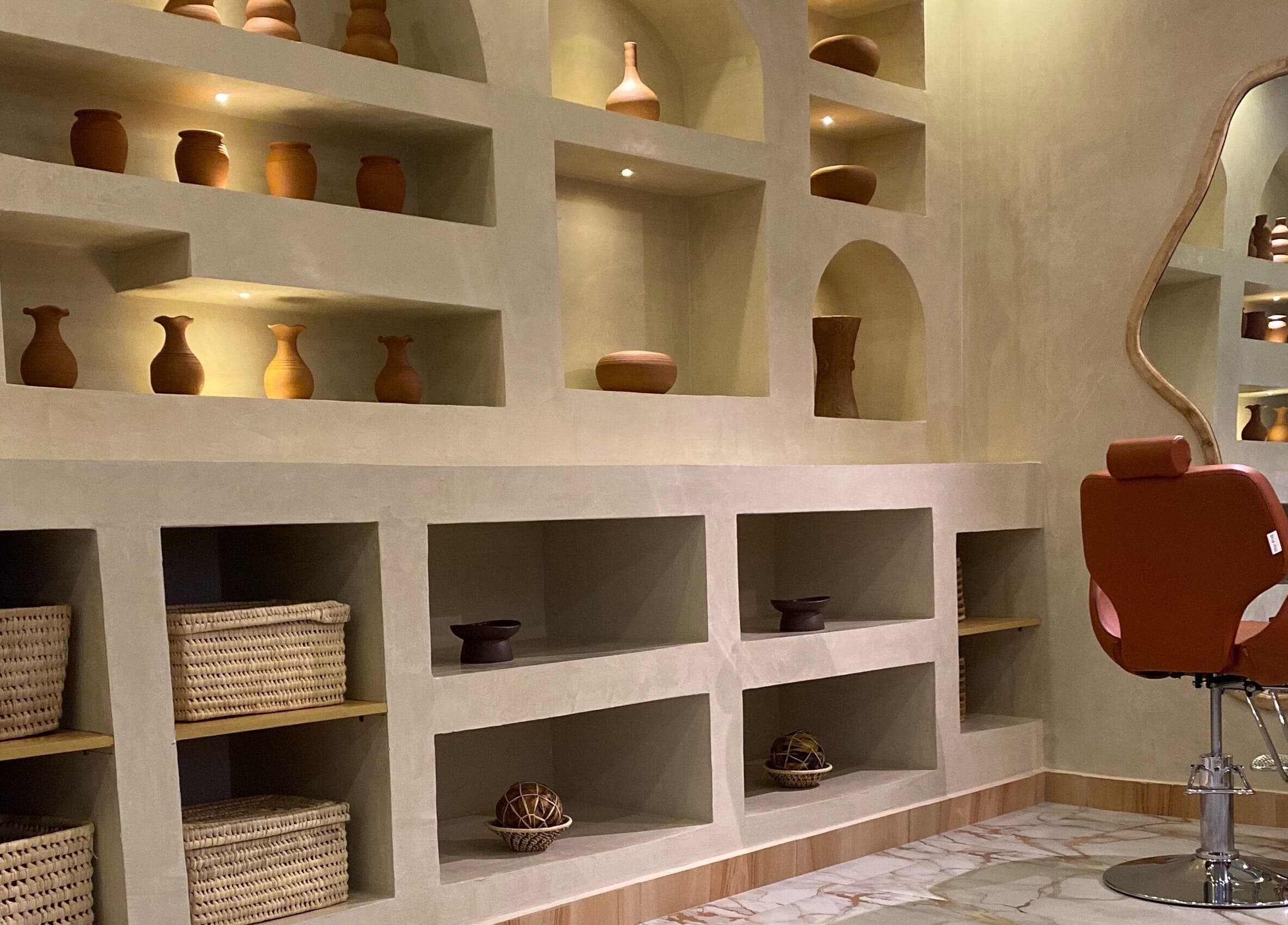 Elegant salon interior at The Pod, Kampala, Central Region, UG with pottery decor and styling chair.