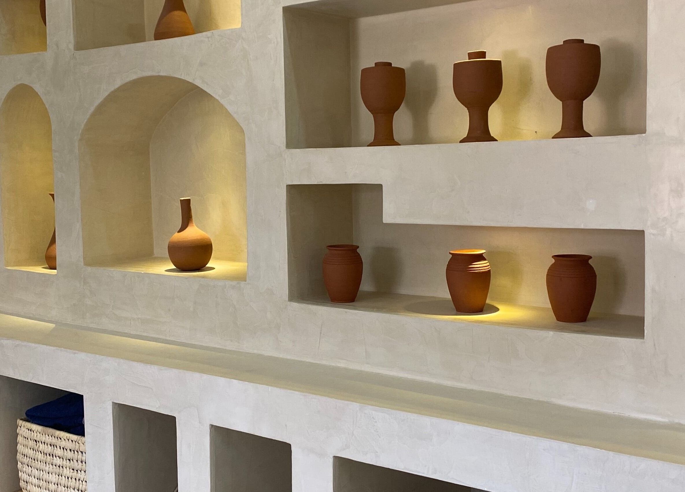 Decorative clay pots on an elegant shelf at The Pod, Kampala, Central Region, UG creating a warm, welcoming ambiance.