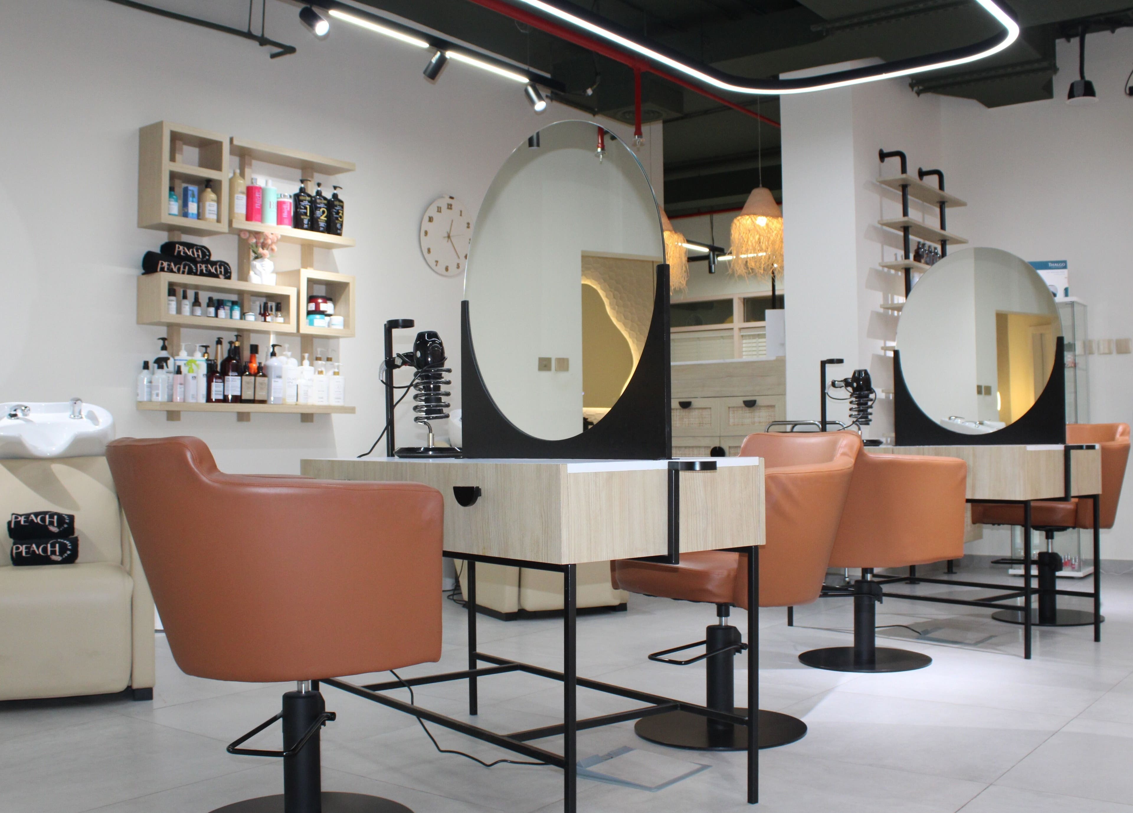 Modern salon interior at Peach Beauty Bar, Dubai, Dubai, AE, showcasing stylish seating and beauty products.