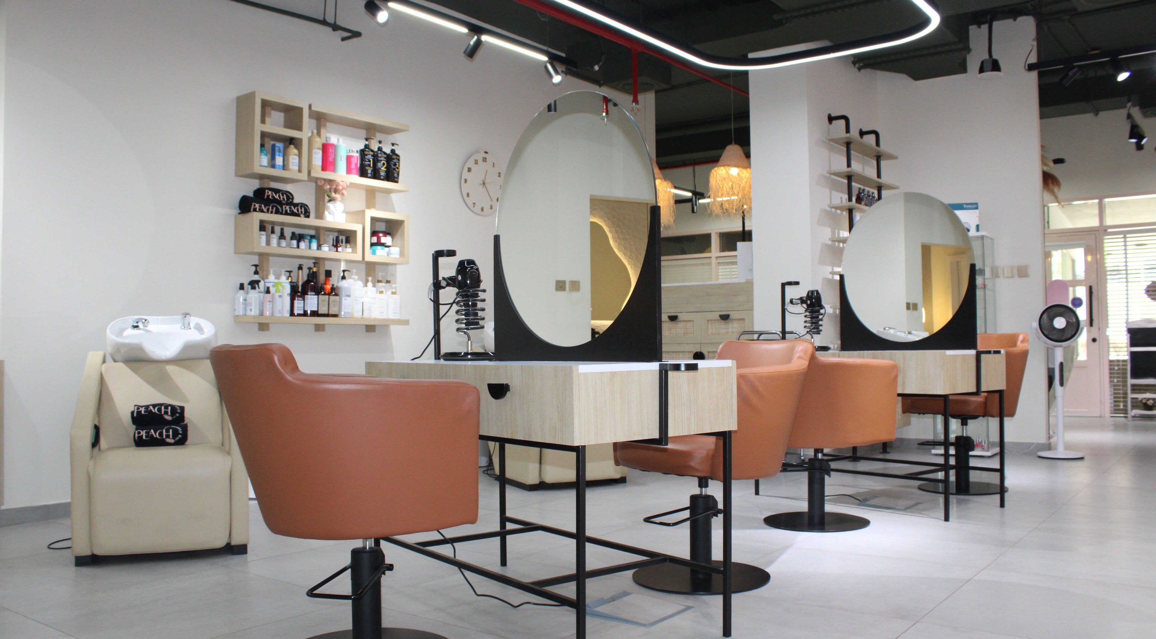 Modern salon interior at Peach Beauty Bar, Dubai, Dubai, AE, showcasing stylish seating and beauty products.