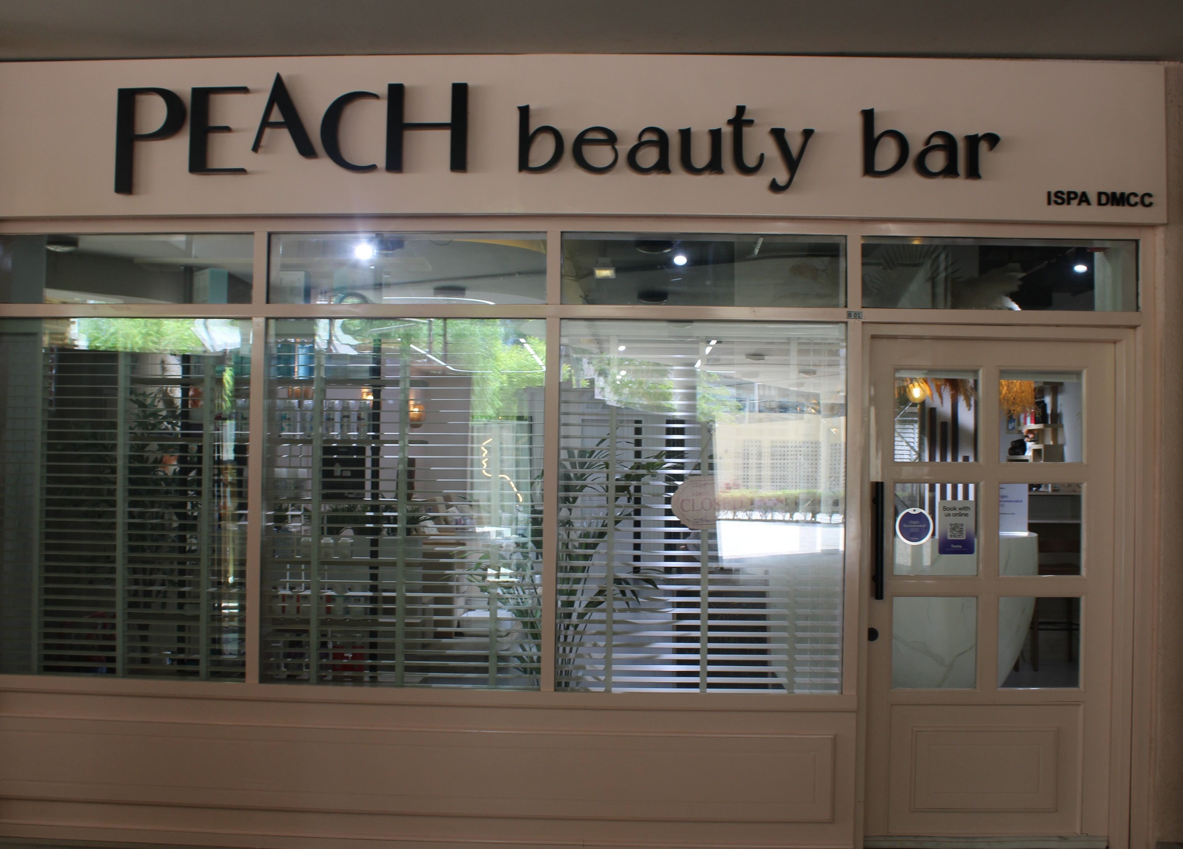 Exterior of Peach Beauty Bar in Dubai, Dubai, AE, featuring modern design with large windows and elegant signage.