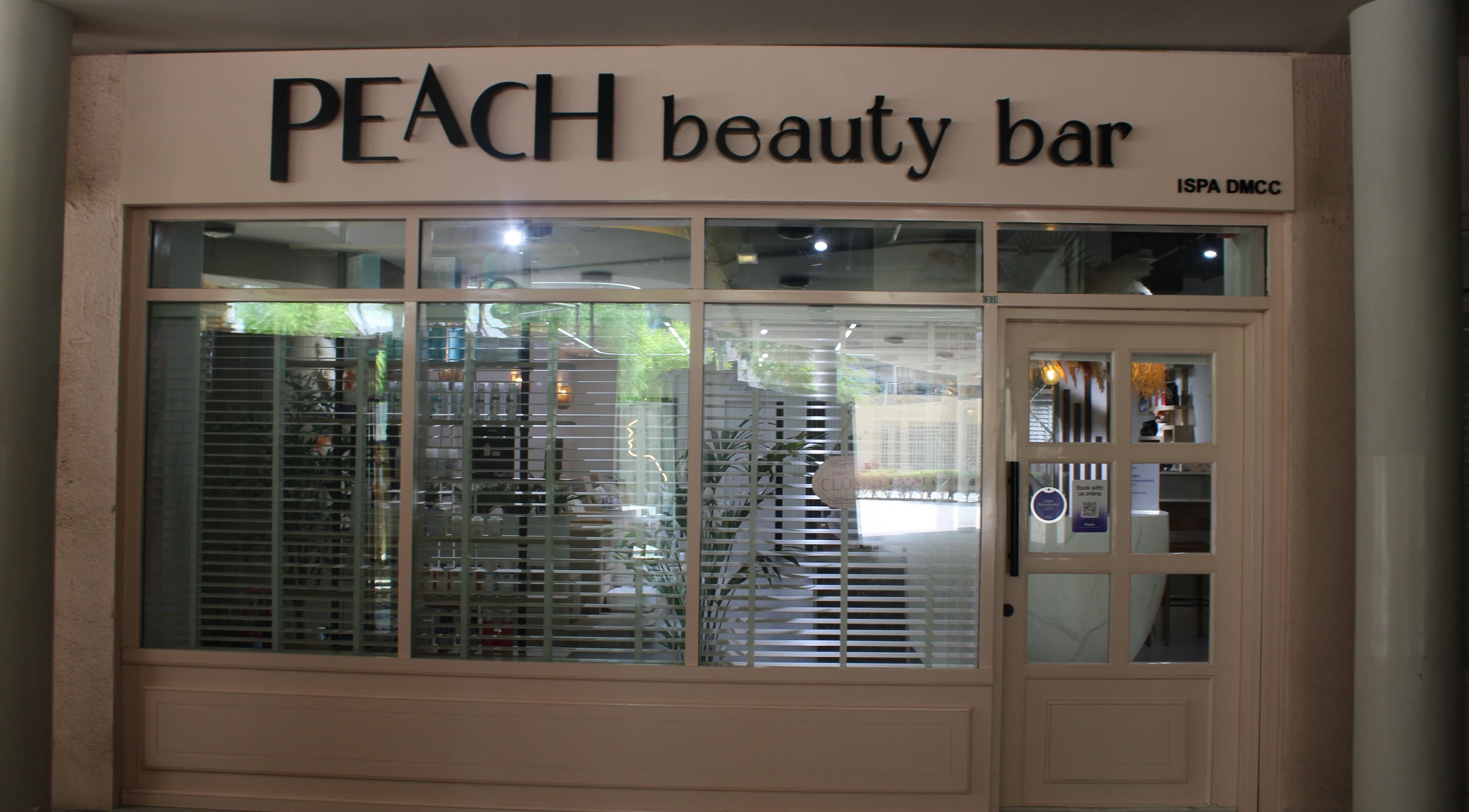 Exterior of Peach Beauty Bar in Dubai, Dubai, AE, featuring modern design with large windows and elegant signage.