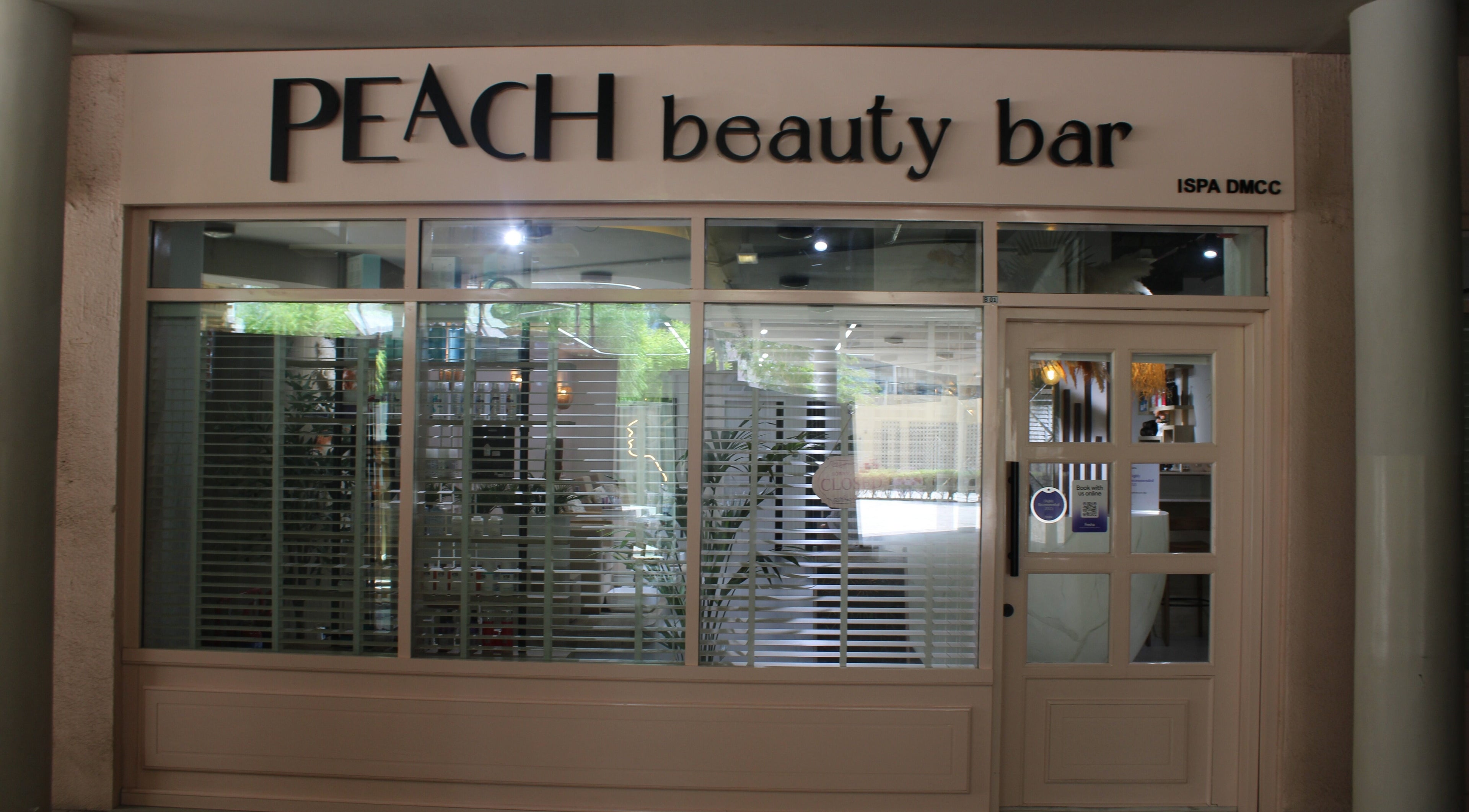 Exterior of Peach Beauty Bar in Dubai, Dubai, AE, featuring modern design with large windows and elegant signage.