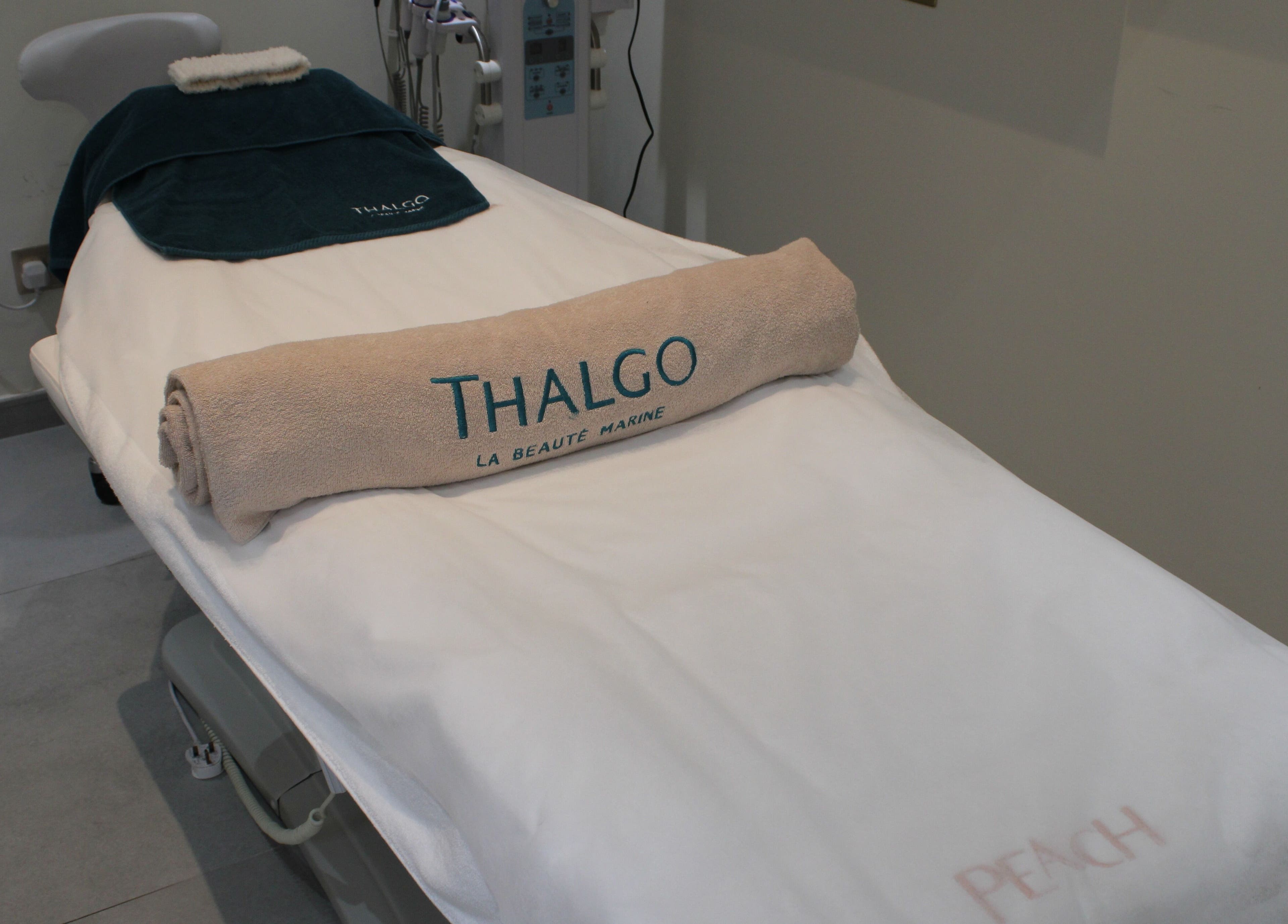 Relaxing treatment bed setup at Peach Beauty Bar, Dubai, Dubai, AE, featuring premium Thalgo towel.