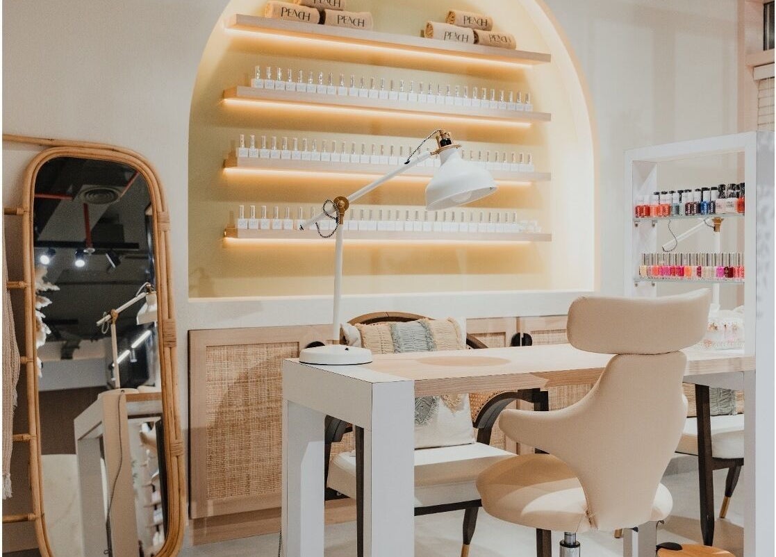 Elegant nail salon setup at Peach Beauty Bar, Dubai, Dubai, AE featuring modern decor and cozy seating.