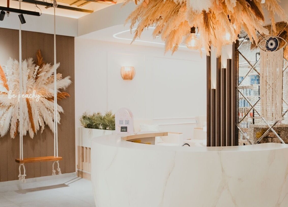 Elegant interior of Peach Beauty Bar with swing and pampas grass decor, located in Dubai, Dubai, AE.