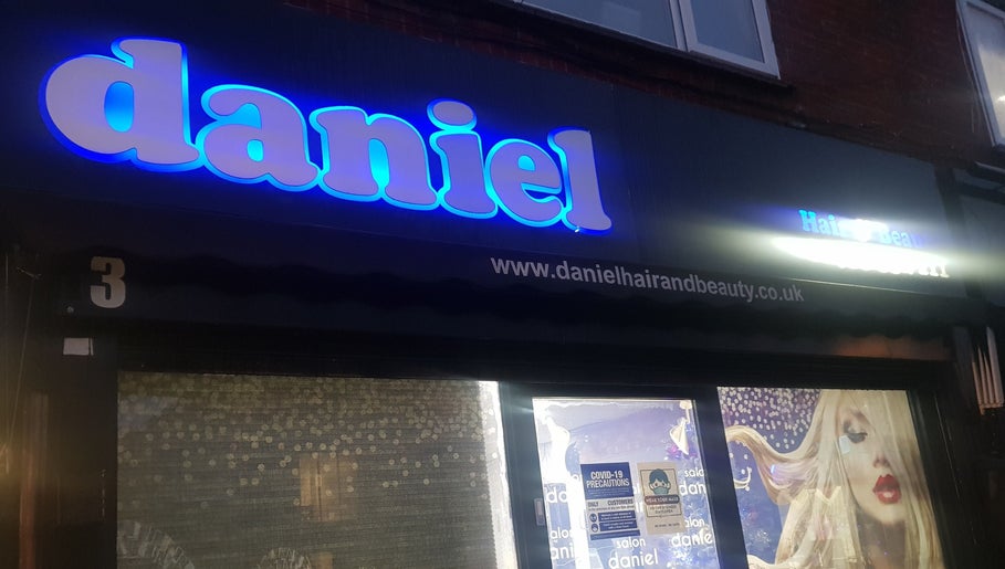 Front shop view of Daniel hair and beauty in Slough, England, GB, featuring a neon sign.