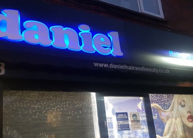 Front shop view of Daniel hair and beauty in Slough, England, GB, featuring a neon sign.