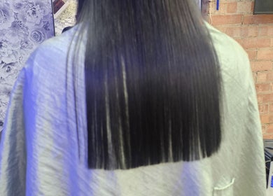 Sleek, straightened hair showcased at Daniel Hair and Beauty, Slough, England, GB.