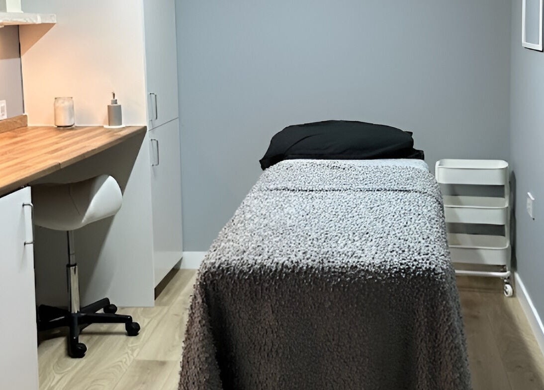 Cozy therapy room at ELM Therapy, Buckingham, England, GB, featuring a comfortable treatment bed and calming decor.