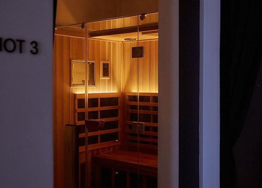 Warm-lit sauna room at Safir House, Merimbula, New South Wales, AU, offering relaxing wellness experiences.